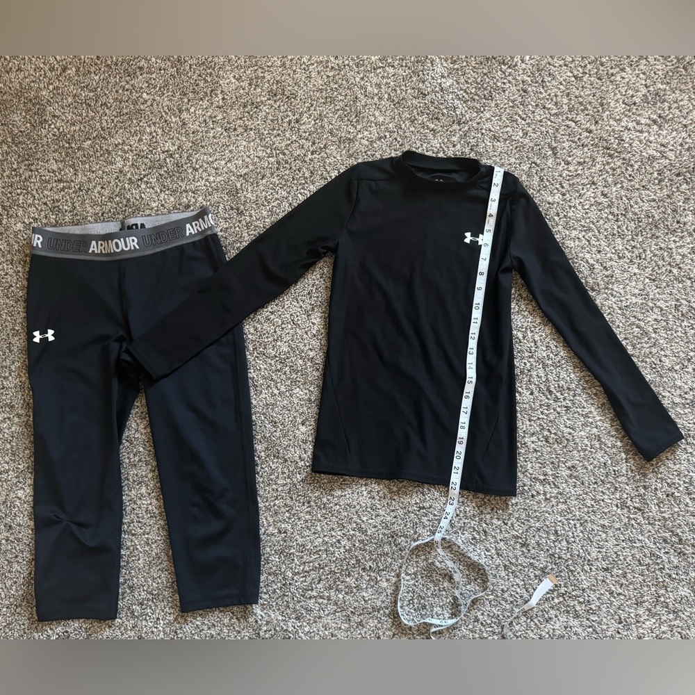 Under Armour Black Top with Red and White logo. Just right to wear for sports.